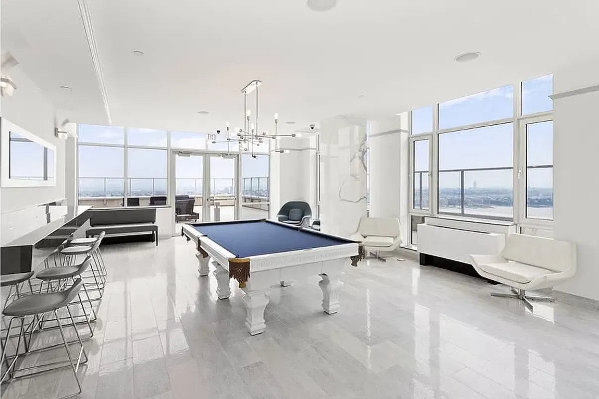 Thumbnail: Building billiards lounge with a white pool table, bar seating and river views