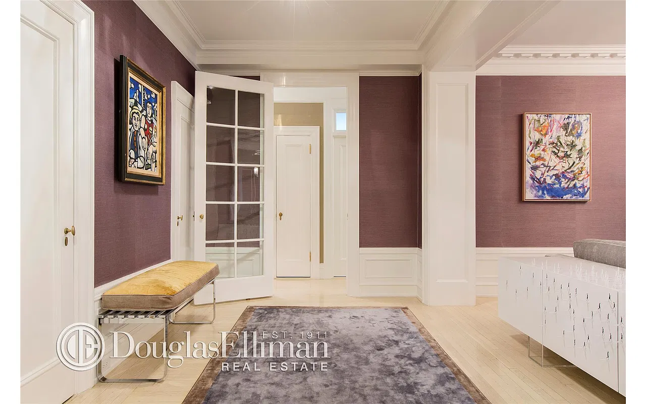 Thumbnail: Entry gallery with plum walls, glass-paned French door, bench and wainscoting