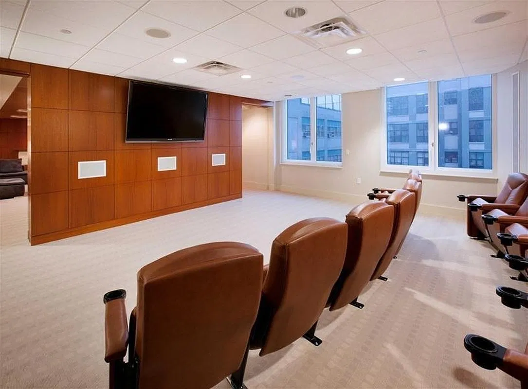 Thumbnail: Screening room with leather theater-style seats facing a wall-mounted screen
