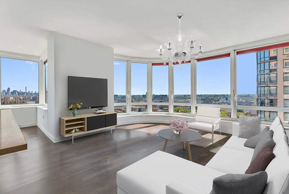 Thumbnail: Same curved-window living room shown with white sofa, chandelier and round coffee table