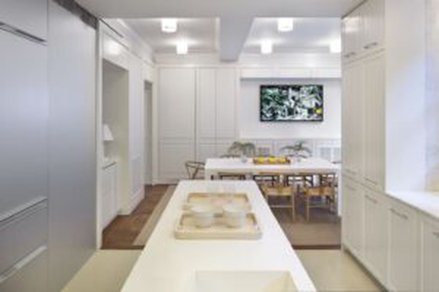 Thumbnail: Eat-in kitchen with white cabinetry, central island and breakfast table
