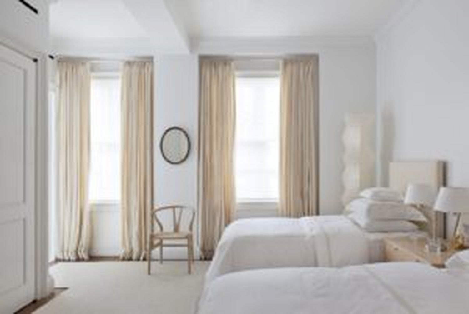 Thumbnail: Bedroom with tall curtained windows, twin beds and wooden chair
