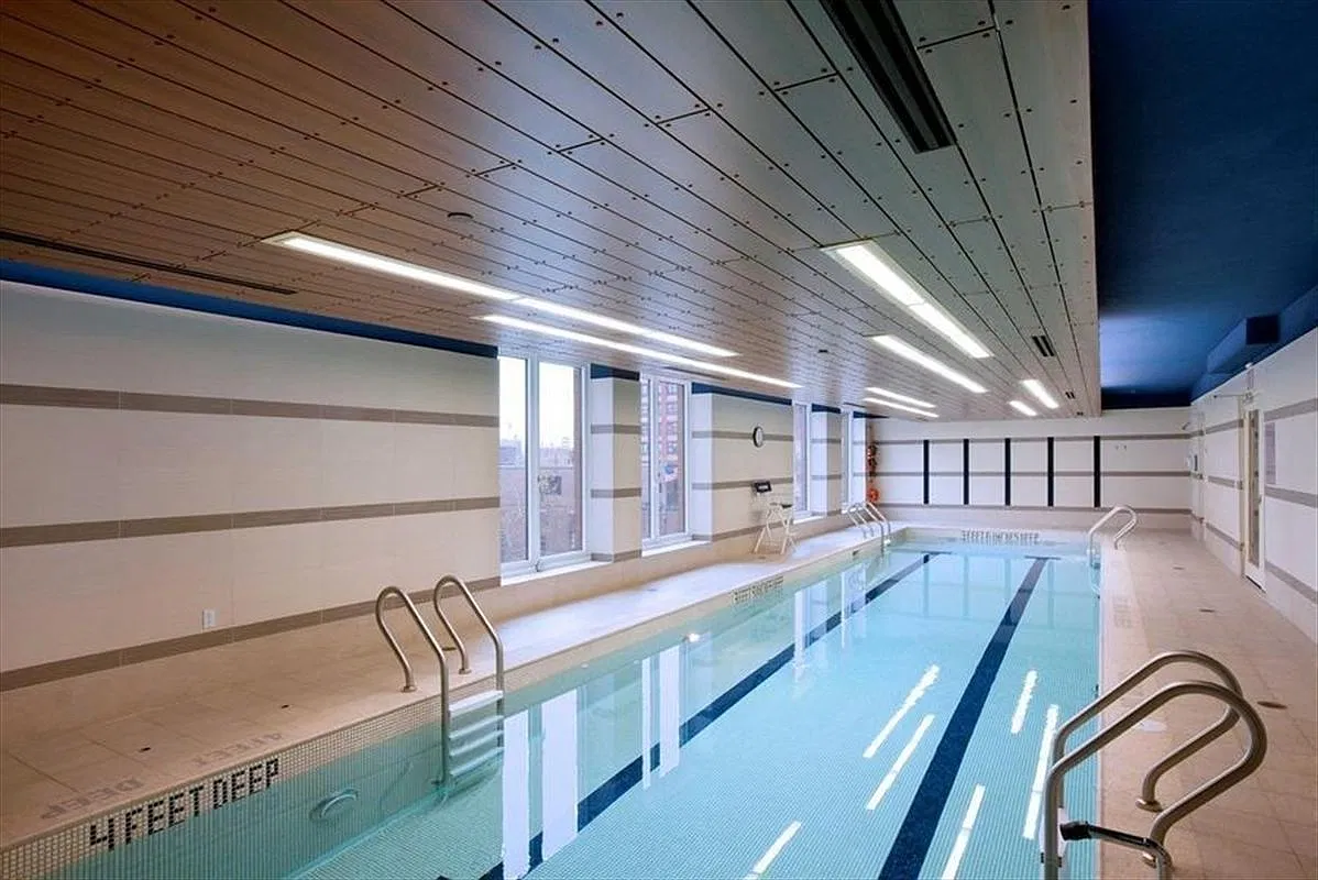 Thumbnail: Indoor lap pool with tiled walls, wood ceiling and tall windows