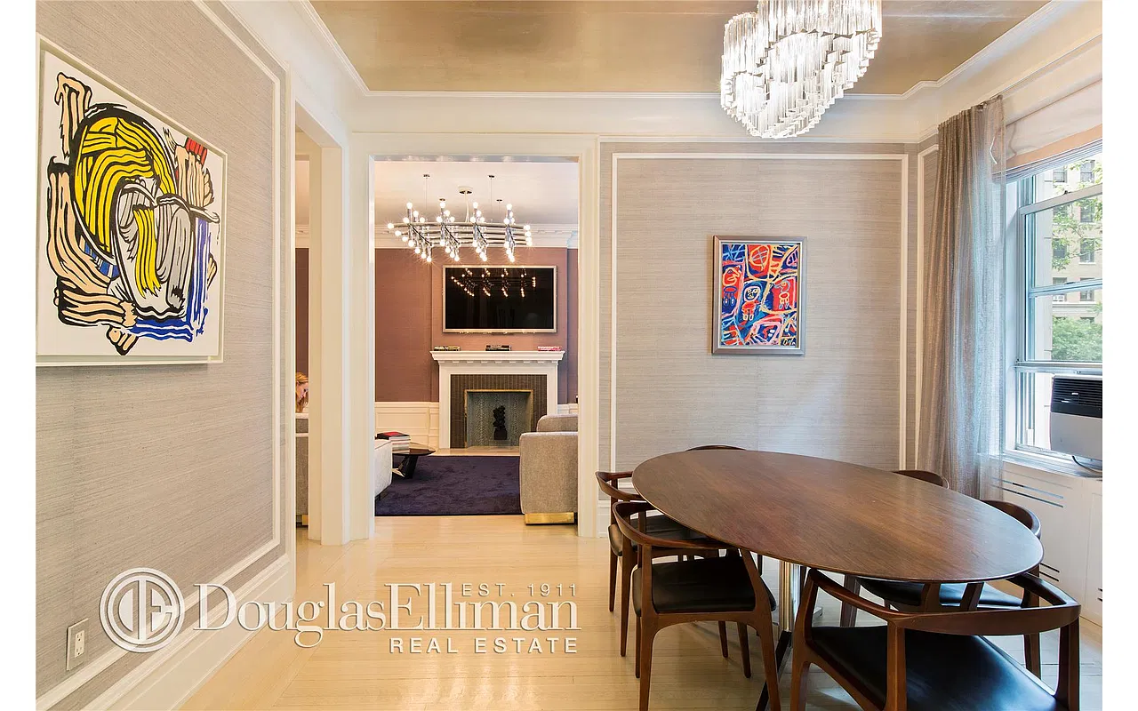 Thumbnail: Formal dining room with oval wood table, crystal chandelier and view into living room