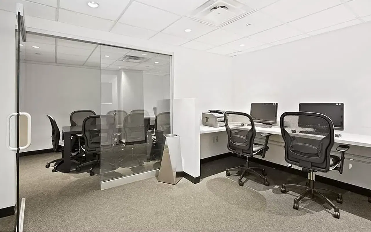 Thumbnail: Building business center with glass-walled conference room and computer workstations