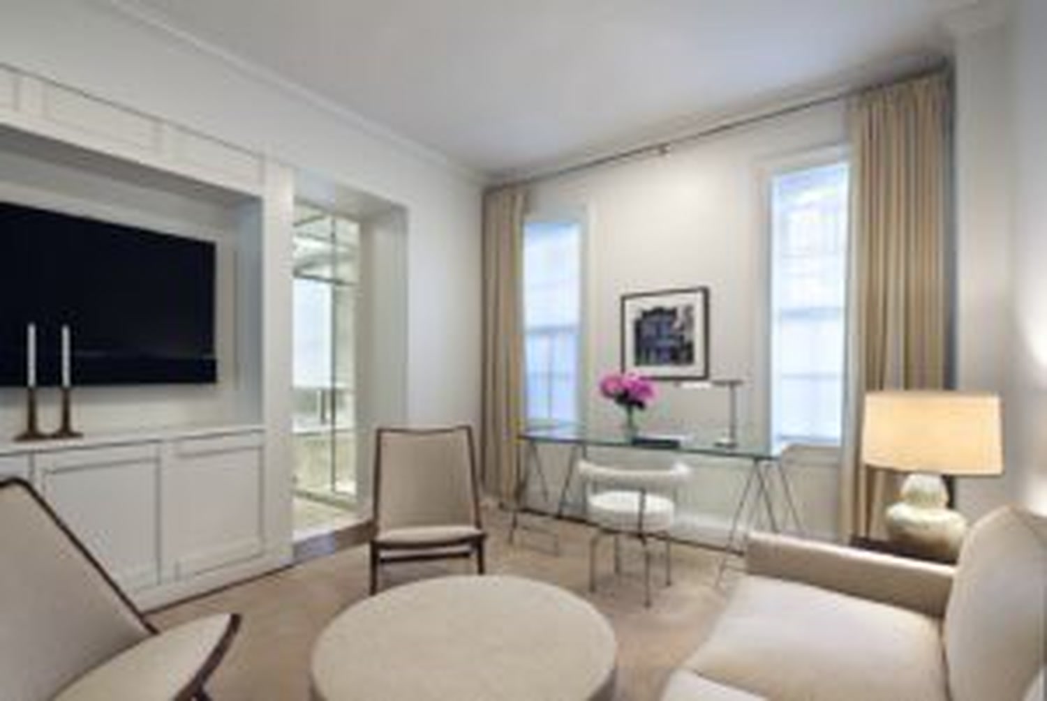 Thumbnail: Library with built-in media wall, glass desk and tall curtained windows