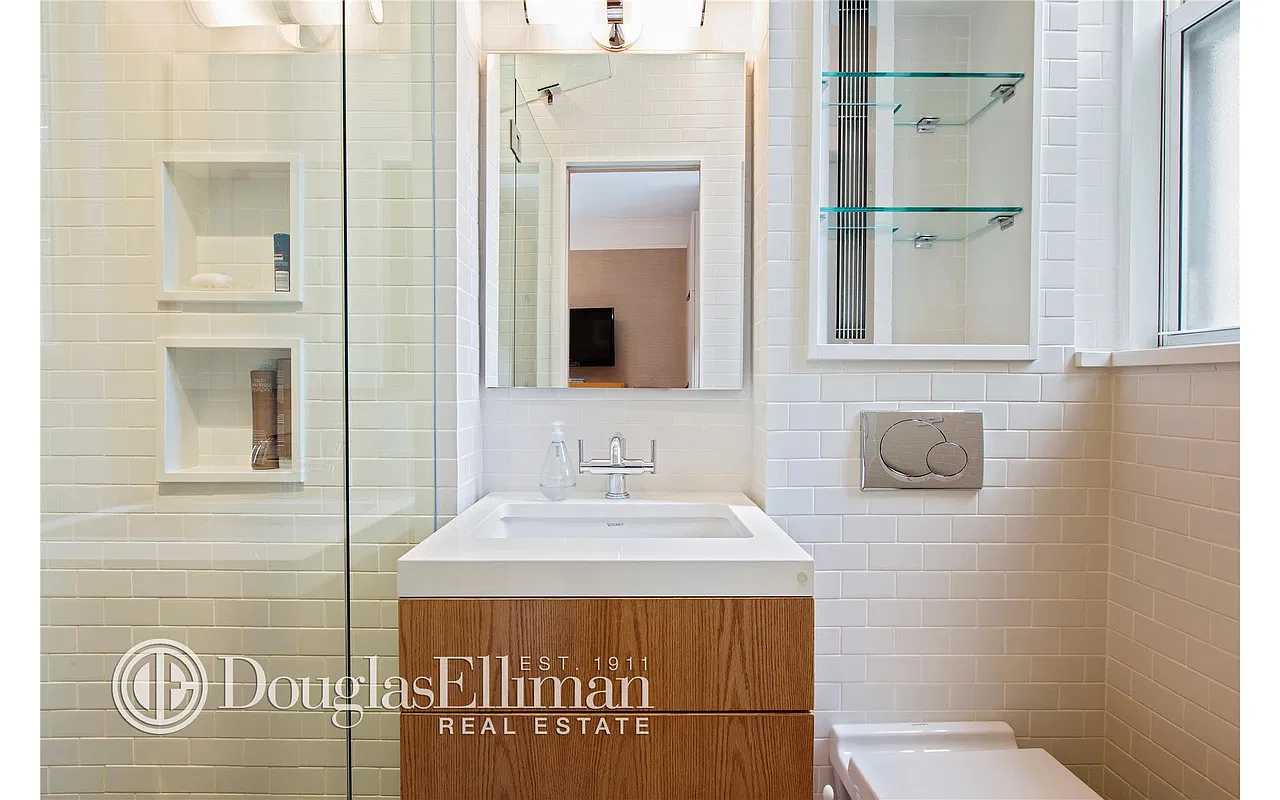 Thumbnail: Bathroom with subway tile, wood vanity, recessed shower niches and glass shower