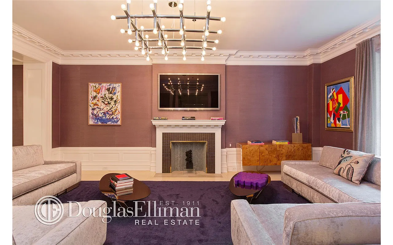 Thumbnail: Living room with decorative fireplace, mounted screen, burl credenza and paired sofas